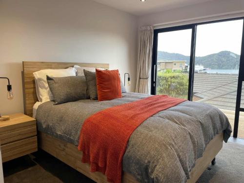 a bedroom with a bed and a large window at Great getaway in Picton