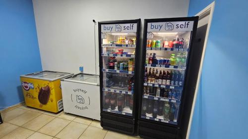 a refrigerator filled with lots of bottles of soda at Quarto Aquarius in Bauru