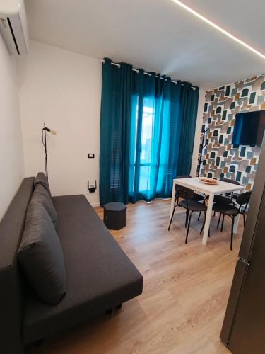 a living room with a couch and a table at MAISON PALMENTELLo 3 in Forza dʼAgro