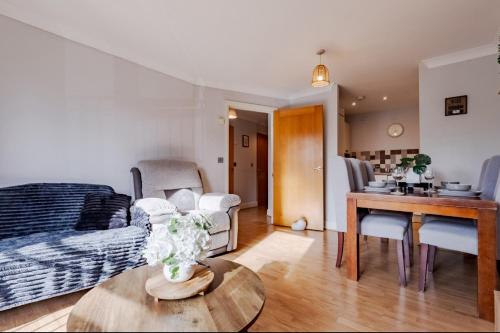 a living room with a bed and a table at Contractor-Friendly, Private Gated Parking, Fast WiFi, Sofa Bed & Netflix, 5-Min Walk to City Centre, 15-Min Walk to Train Station, Ideal for Relocators & Families in Coventry