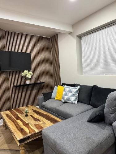 a living room with a couch and a coffee table at Stylish 2 Bed Apt Near Birmingham in Birmingham