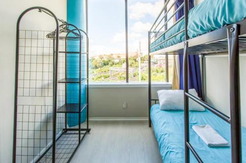a bedroom with two bunk beds and a window at Stars Hostel in Auckland