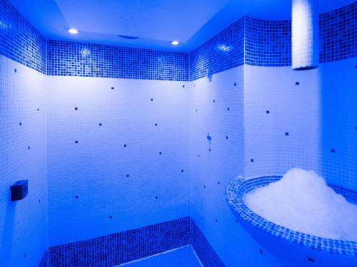 a blue bathroom with a tub covered in snow at Mercure Manchester Norton Grange Hotel & Spa in Rochdale