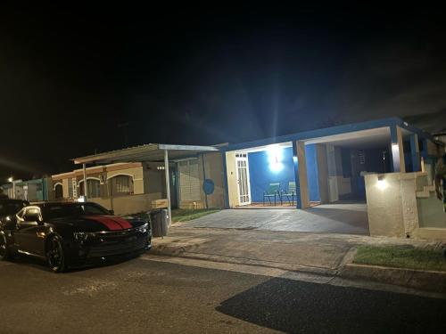 a car parked in front of a house at night at Caleño Boricua Apartment in Quebradillas