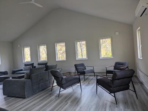 a waiting room with chairs and tables and windows at Wakaba Niseko 新築1棟貸切 in Rankoshi