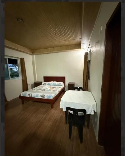 a bedroom with a bed and a table in it at Panglao Haven in Panglao Island