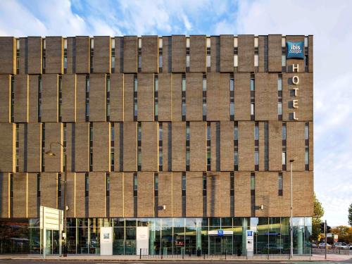 a brown building with windows on a street at ibis Budget Manchester Centre Pollard Street in Manchester