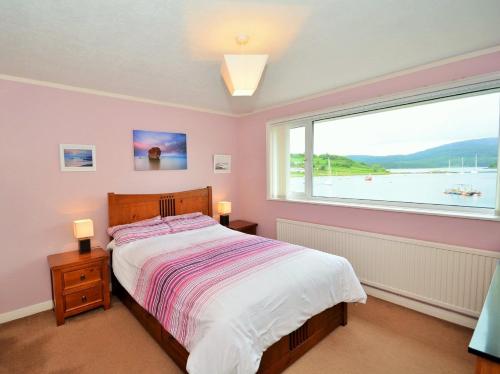 a bedroom with a bed and a large window at 2 bed in Lochgilphead AG692 in Tayvallich