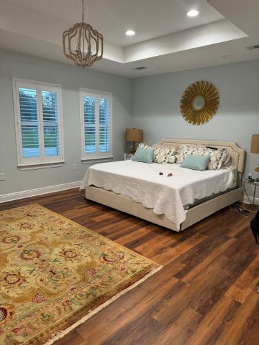 a bedroom with a large bed and a rug at Gulfport home perfect for family holidays in Gulfport