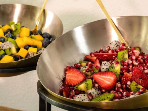 two metal bowls filled with fruit on a table at ibis Bengaluru Hosur Road - An Accor Brand in Bengaluru