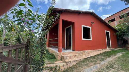 una casa roja con una valla delante en Maison in Mulungu, en Mulungu