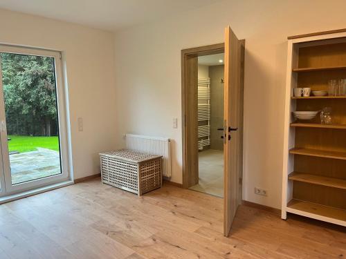 an empty room with a door and a room with a window at 4-Steine-Blick, Wohnung 2 in Schöna