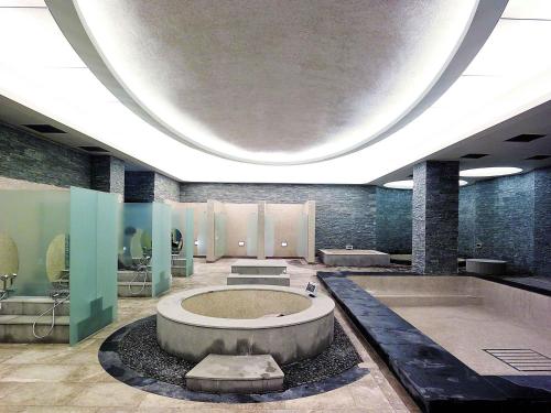 a bathroom with a large tub in the middle of a room at Grand Mercure Ambassador Changwon in Changwon