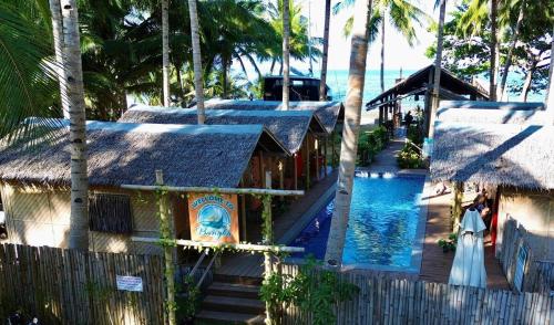 a woman in a wedding dress standing next to a pool at The Bangka Beach Guesthouse in Siquijor