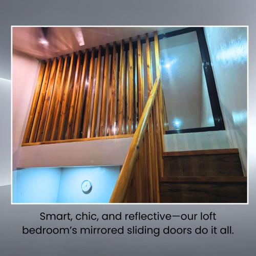 a wooden staircase with a window in a room at Belnidoloft apartment near airport unit1 in El Nido