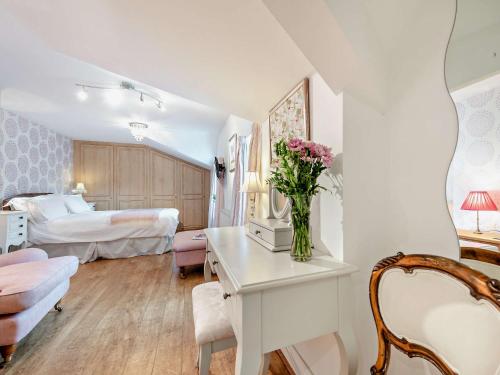 a white room with a bedroom with a bed and a table at 3 bed in Aberaeron 86578 in Aberaeron