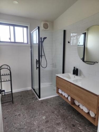 a bathroom with a shower and a sink at Seaspray Caravan Park in Seaspray