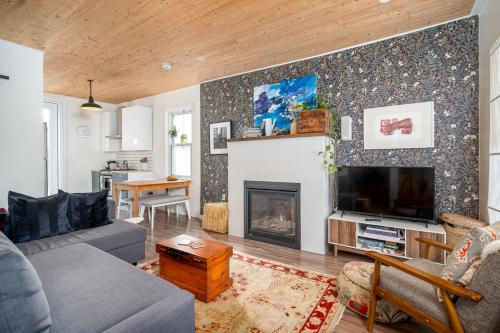 a living room with a couch and a fireplace at Artistic Picton getaway in Picton