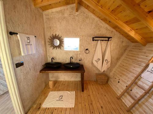 a bathroom with two sinks on a wooden table at La Pointe d'Or Hotel Dakhla in Dakhla