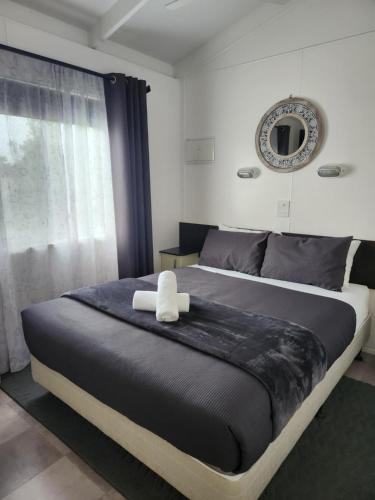 a bedroom with a large bed with a large window at Seaspray Caravan Park in Seaspray