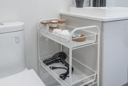 a white shelf in a kitchen next to a sink at Cozy Corner - Modern 1BR in MTL in Montréal