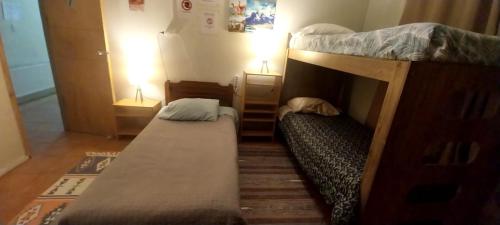 a small room with two bunk beds in it at Patagonia Mágica in Punta Arenas