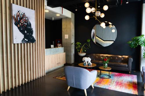 a living room with a couch and a table at ExpoStay Hotel Corferias Embajada Americana in Bogotá