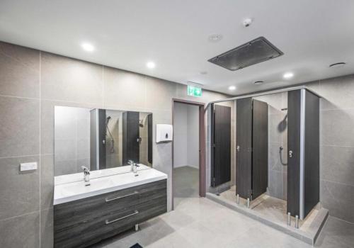 a bathroom with a sink and a shower at Stars Hostel in Auckland