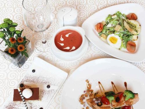 a table with two plates of food on it at Pullman Zhangjiajie Hotel in Zhangjiajie