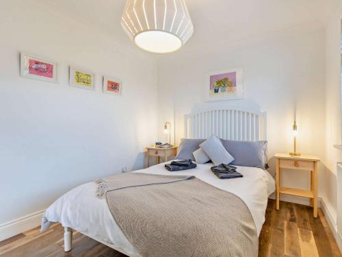 a bedroom with a bed with two towels on it at 2 Bed in Bacton 75392 in Bacton
