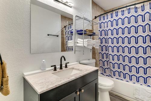 a bathroom with a sink and a shower curtain at 9 Mi to Legoland Family Gem with Games Galore! in Eagle Lake