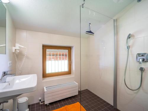a bathroom with a sink and a shower at Ferienhaus Almhof in Gerlosberg