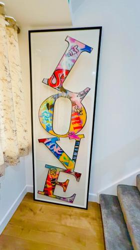 a framed picture of a group of signs on a wall at DSK Residencia in Maidstone