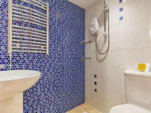 a bathroom with a shower and a toilet and a sink at 2 Bed in Fowey 76446 in Golant