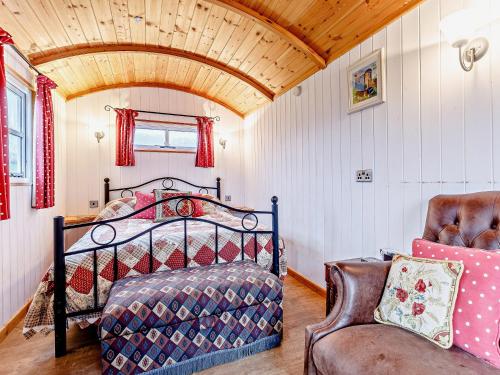 a bedroom with a bed and a chair at 1 Bed in Ironbridge 80587 in Leighton