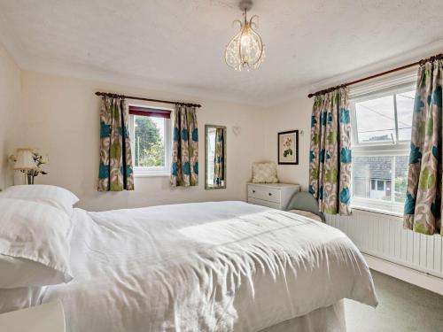 a bedroom with a large white bed and windows at 3 Bed in Briston 90184 in Briston