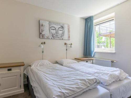 a bedroom with two beds and a window at Assum Great in Uitgeest