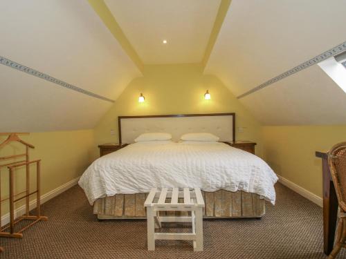 En eller flere senge i et værelse på Wash House Cottage