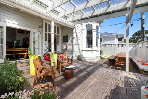 a patio with chairs and a table on a house at Worldwide Backpackers in Wellington