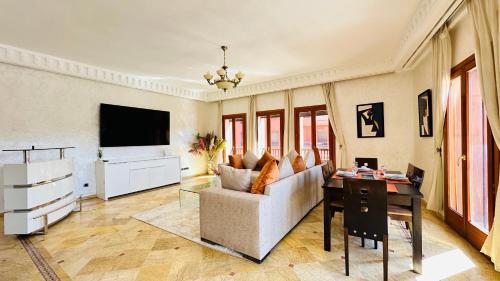 a living room with a couch and a table at Heart of Marrakech Chic & Central Gueliz Apartment - Free parking in Marrakech