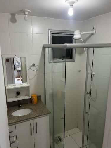 a bathroom with a glass shower and a sink at Apartamento 2 dormitórios in Ananindeua