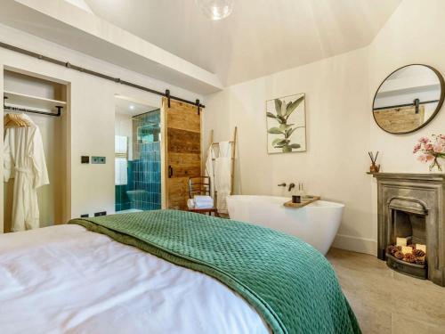 a bathroom with a bed and a tub and a fireplace at 1 Bed in Durham 89318 in Witton Gilbert