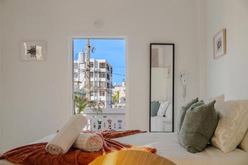 a white room with a couch and a window at Luma Boutique Collection by PH in San Juan
