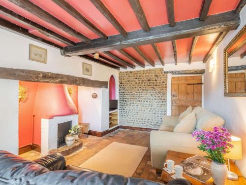 a living room with a couch and a fireplace at 2 Bed in Bacton 88326 in Bacton