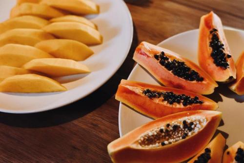 a plate with slices of fruit on a table at Pousada Erva Doce in Arraial d'Ajuda