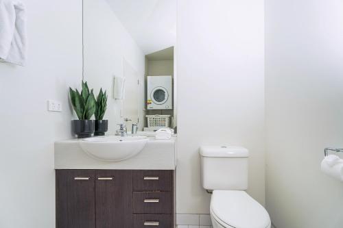 a bathroom with a sink and a toilet at Sea Views at 7 - Beachside Apartment in Whitianga