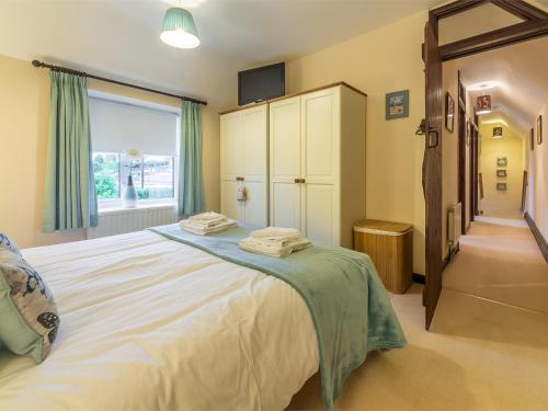 a bedroom with a large bed and a window at 3 bed property in Sedgeford KT092 in Sedgeford