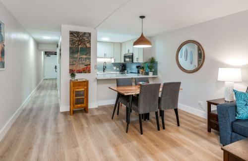 a kitchen and dining room with a table and chairs at Charming Beachside Garden Vistas in Wailea