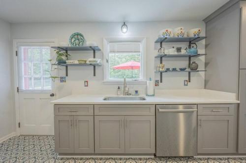 a kitchen with a sink and a window at Restful Riverside Residence w Firepit in Athens