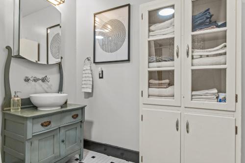 une salle de bain avec un lavabo et un miroir dans l'établissement Lenoir Cottage w covered patio and fire pit, à Athens